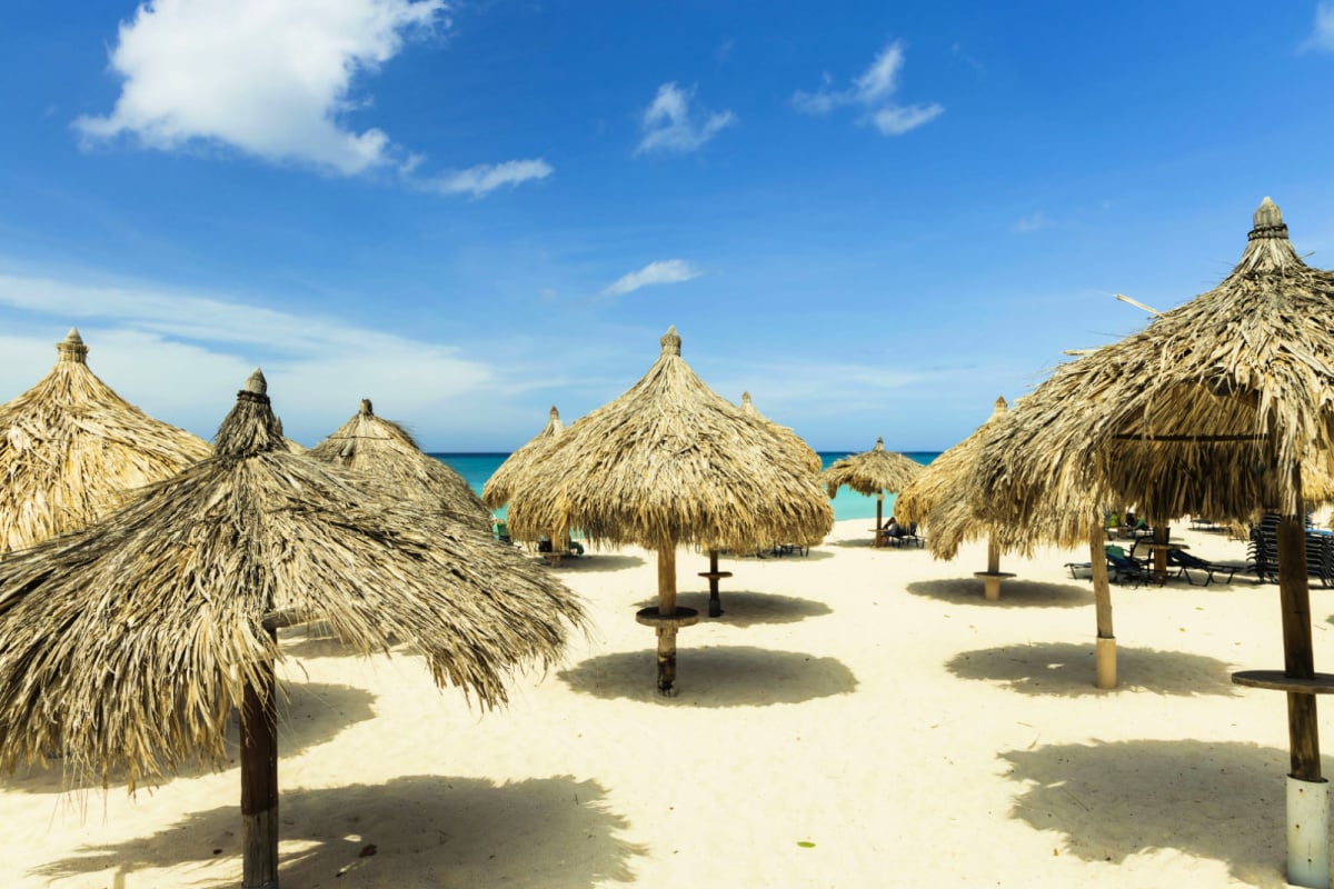 View of palapas on the beach in Aruba